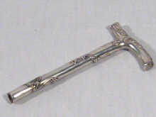 Appraisal: A silver parasol handle with T shaped handle and sinuous