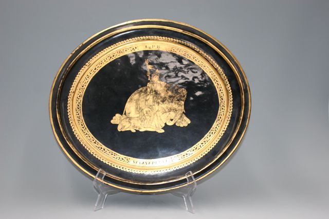 Appraisal: A Burmese oval platter gold on black lacquer decorative platter