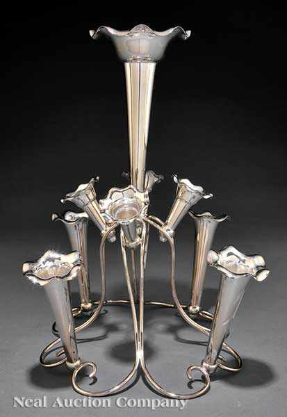 Appraisal: An English Victorian Silverplate Epergne c the sinuous scroll frame