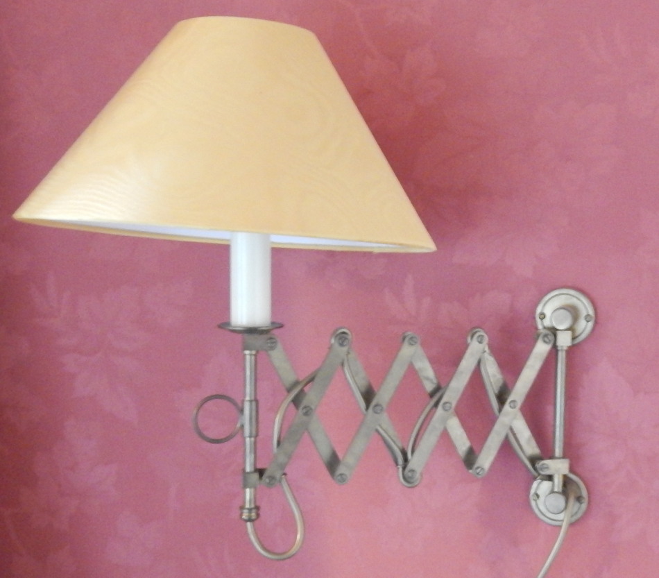 Appraisal: A pair of brass adjustable wall lights each with a