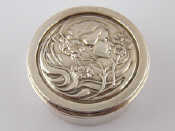 Appraisal: A silver circular trinket box the hinged lid with Art