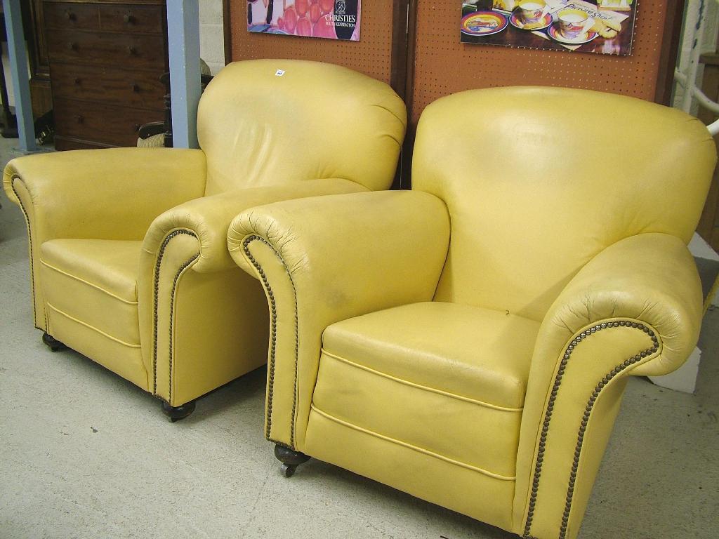 Appraisal: Pair of 's cream leather upholstered deep back armchairs each