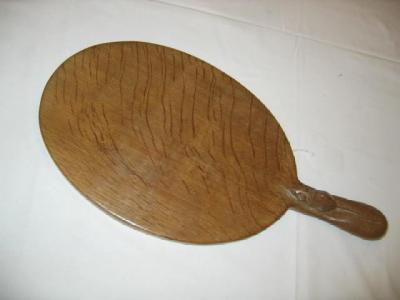 Appraisal: AN ADZED OAK CHEESE BOARD by Robert Mouseman Thompson of