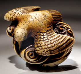 Appraisal: CARVED IVORY NETSUKE Carved and stained ivory netsuke of a