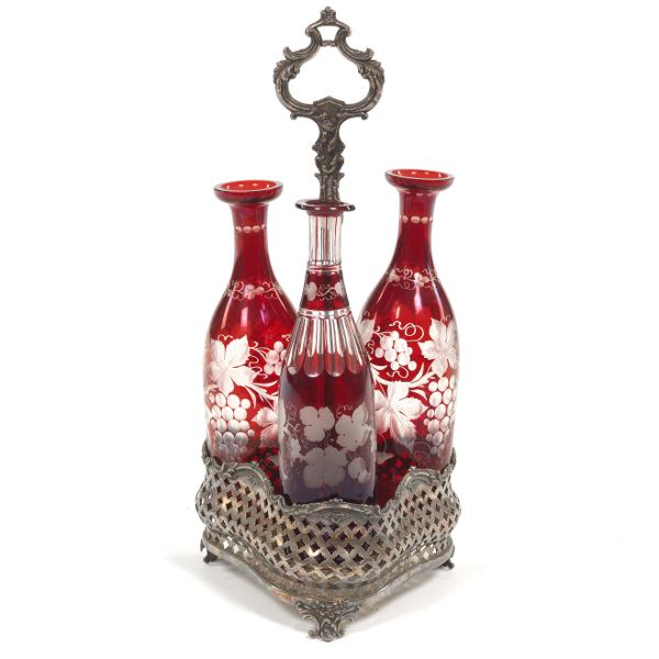 Appraisal: THREE BOHEMIAN RUBY RED CRUET SET ON SILVER PLATED HOLDER