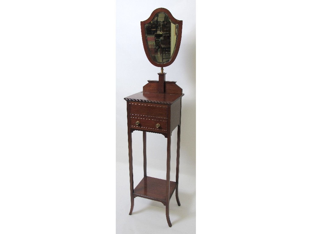 Appraisal: An Edwardian mahogany dressing wig stand with an adjustable shield