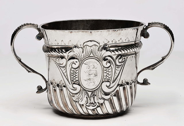 Appraisal: A QUEEN ANNE SILVER PORRINGER with stamped decoration London and