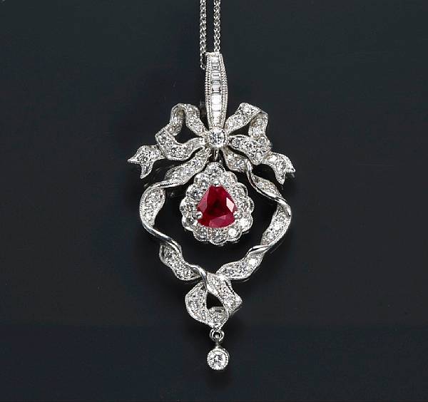 Appraisal: A ruby and diamond pendant with chain suspending a triangular-shaped