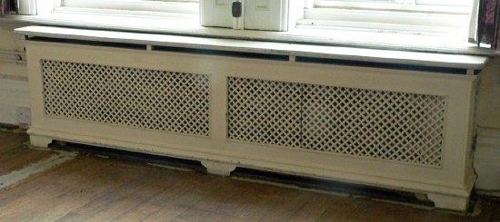 Appraisal: A double pierced cast radiator surround with marble top on