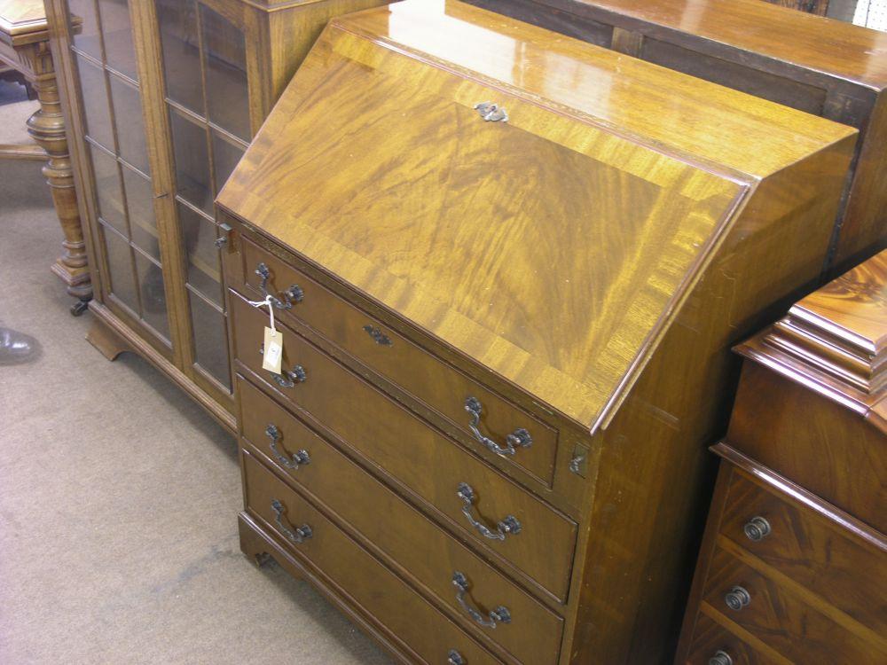 Appraisal: A reproduction mahogany veneered bureau cross-banded fall front enclosing fitted