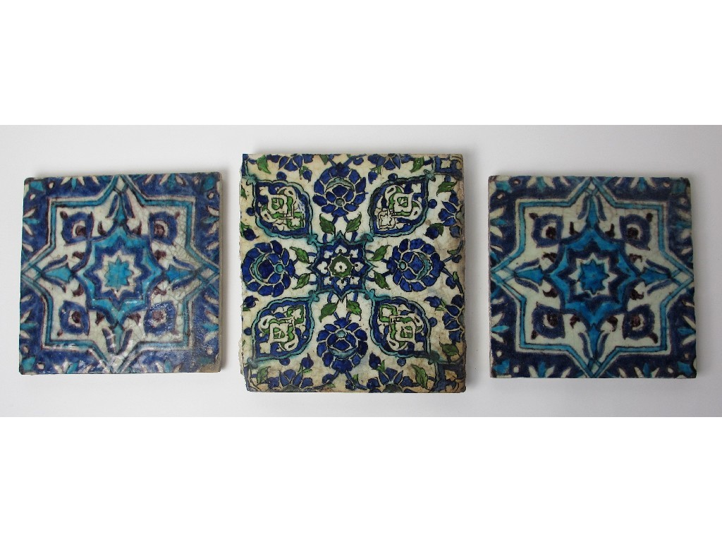 Appraisal: Two Persian blue and white moulded tiles painted with geometric