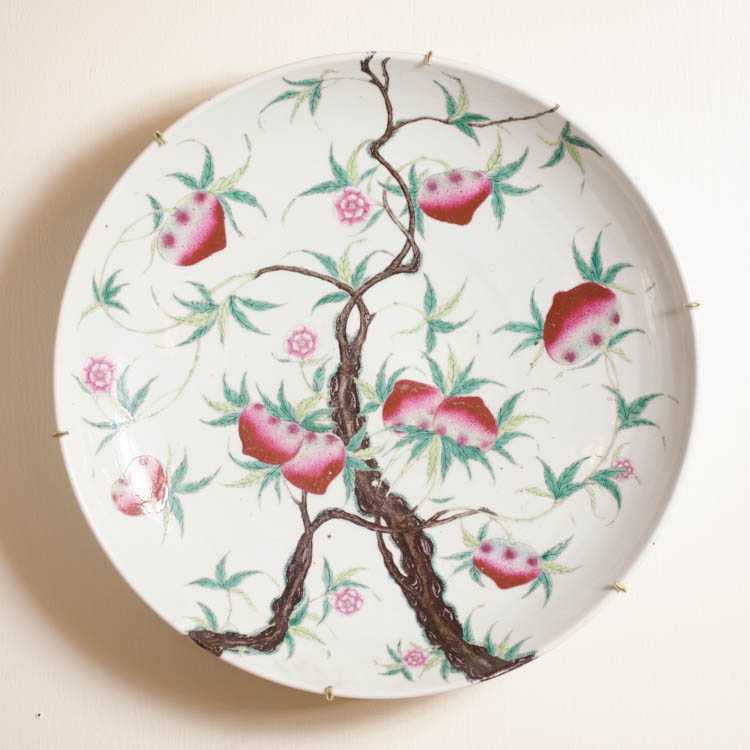 Appraisal: CHINESE PORCELAIN CHARGER hand enameled featuring cross edge peach tree