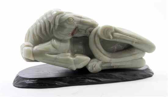 Appraisal: A Carved Jade Horse of celadon hue with russet veining