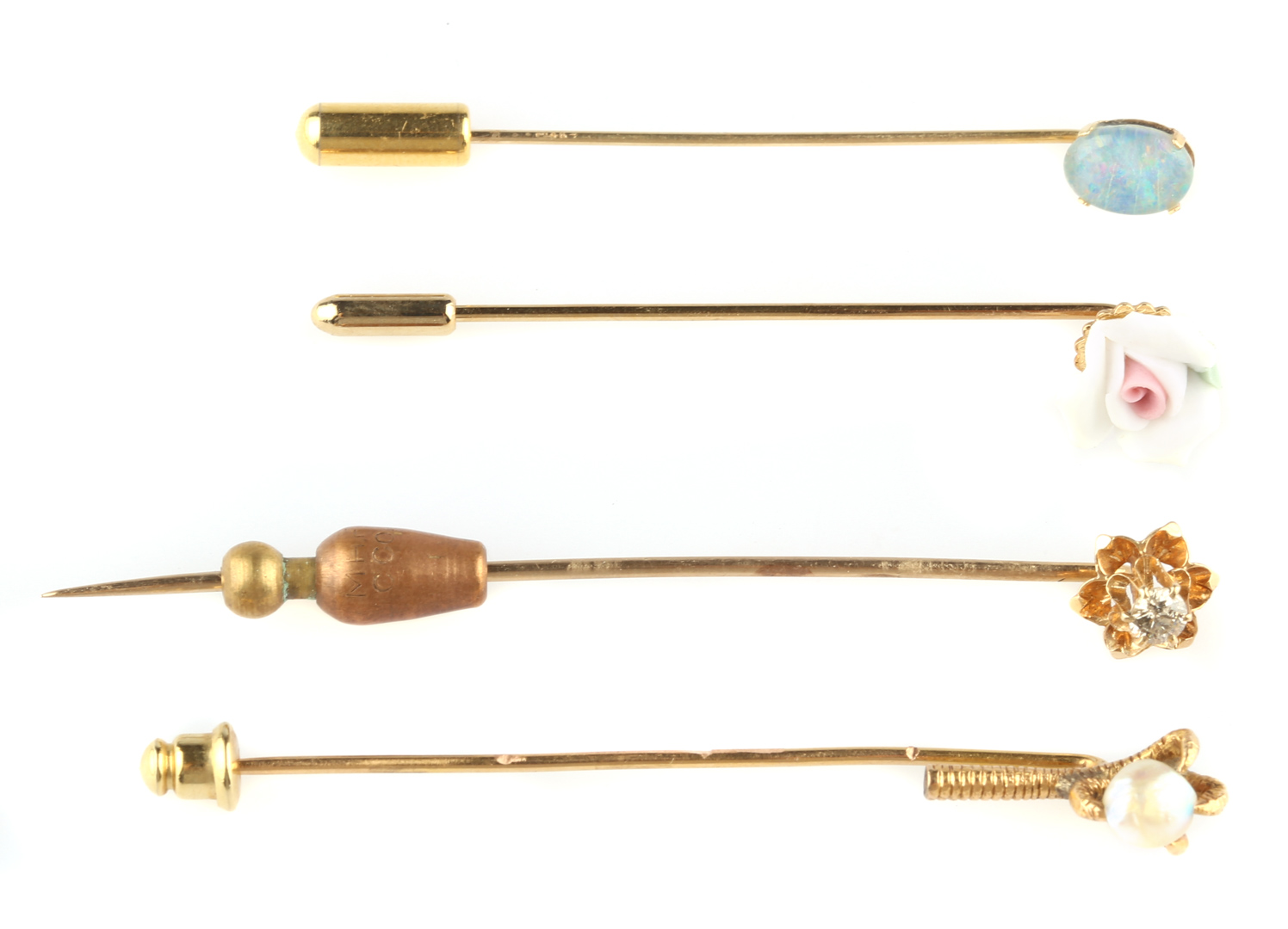 Appraisal: Four Stick Pins Diamond opal pearl and a floral stick