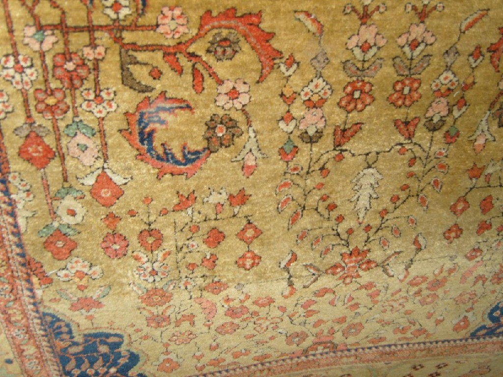 Appraisal: A Persian rug with pale fawn field with floral detail