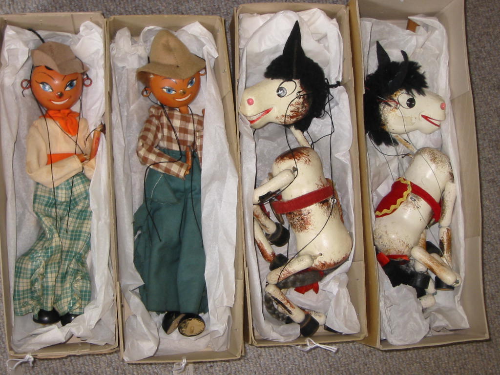 Appraisal: Four Pelham puppets two 's SS Cowboy with lead hands