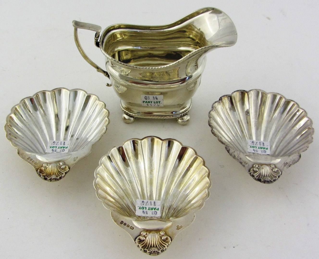 Appraisal: A silver helmet shaped milk jug raised on bun feet