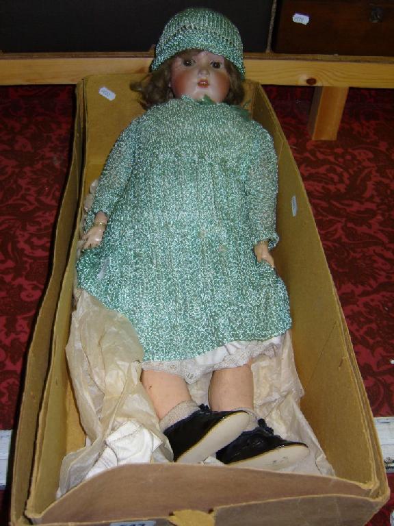 Appraisal: A boxed German bisque headed doll with closing brown eyes