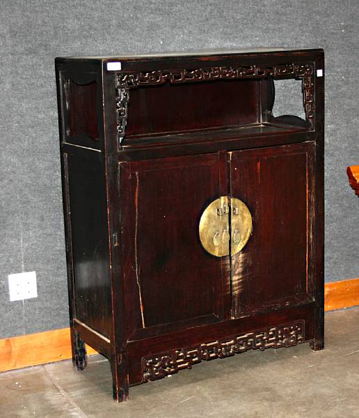 Appraisal: A mixed hardwood storage cabinet th Century Built with reticulated