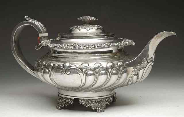 Appraisal: A GEORGE IV SILVER TEAPOT with cast scroll and shell