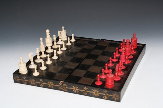 Appraisal: A TURNED AND STAINED IVORY CHESS SET cm high with