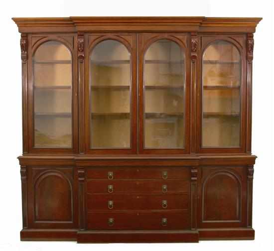 Appraisal: English mahogany breakfront bookcase late th century scrolling broken arch