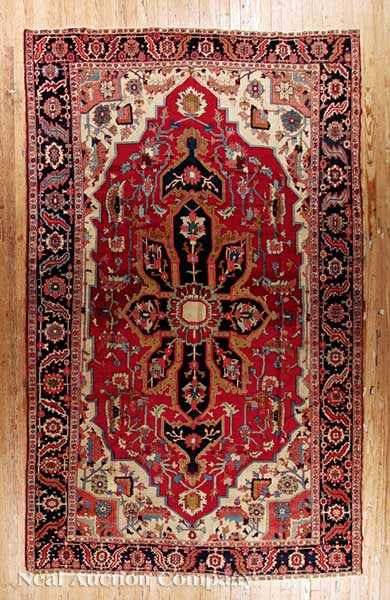 Appraisal: A Fine Antique Persian Serapi Carpet crimson ground central radiating