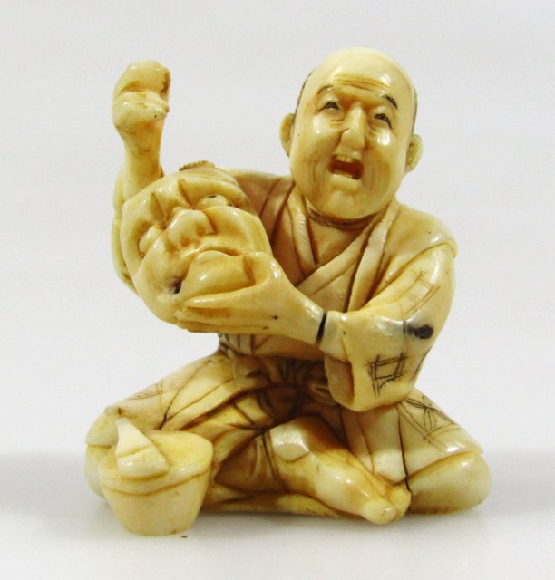 Appraisal: A thC Japanese ivory netsuke formed as seated gentleman in