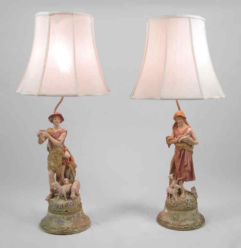 Appraisal: PAIR PORCELAIN FIGURAL LAMPS Depicting sheep tenders the porcelain figures