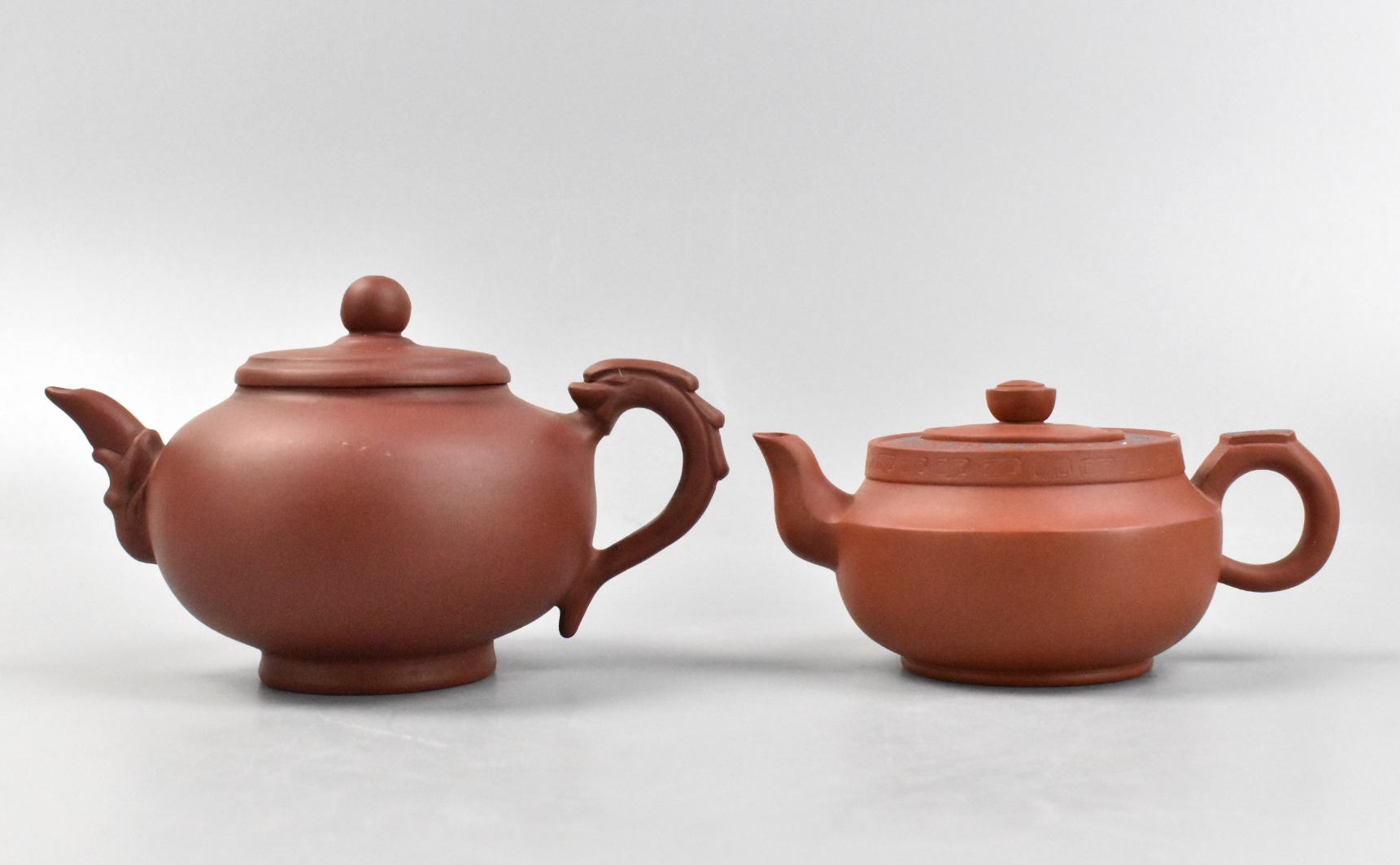 Appraisal: Two Chinese zisha covered teapots The larger teapot has a