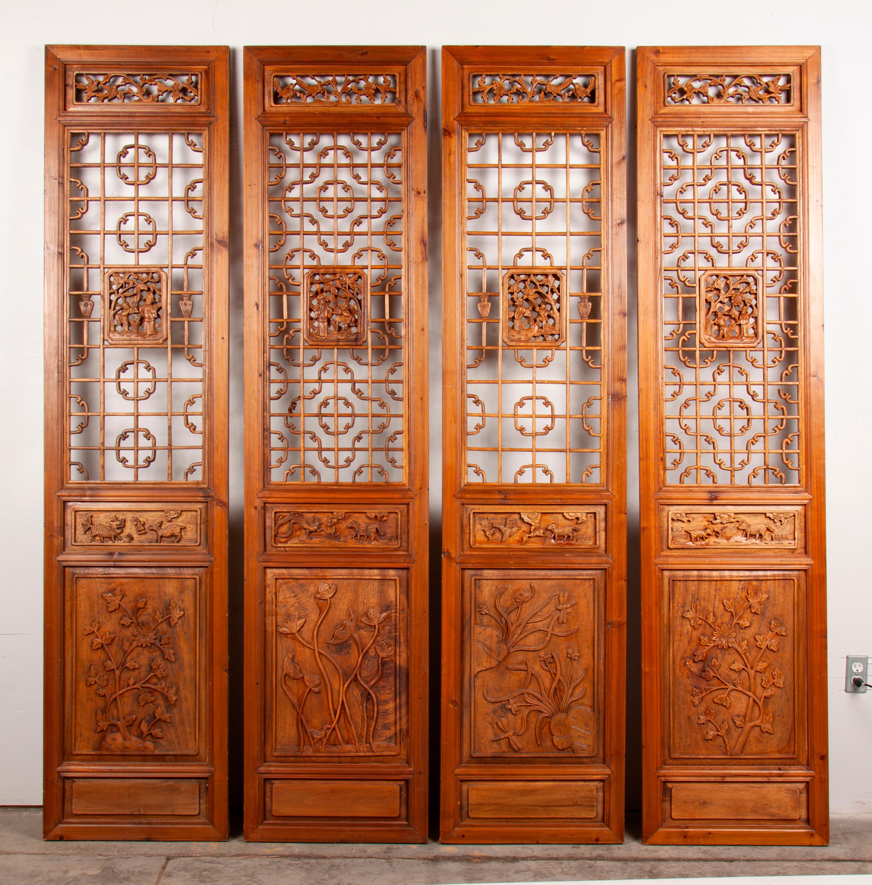 Appraisal: FOUR ELABORATELY CARVED CHINESE ELM DOOR PANELS A set of