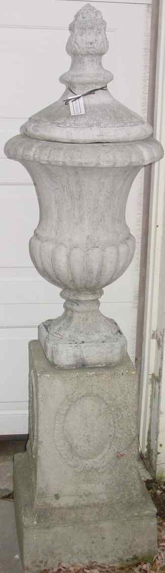 Appraisal: PAIR OF CAST STONE URNS WITH COVERS RAISED ON SQUARE