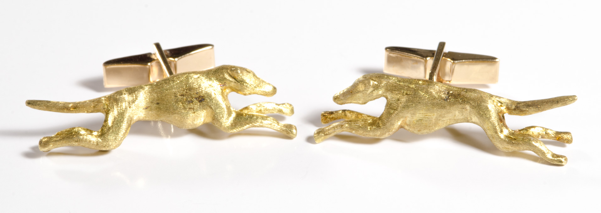 Appraisal: A PAIR OF YELLOW GOLD RUNNING DOG CUFF LINKS each