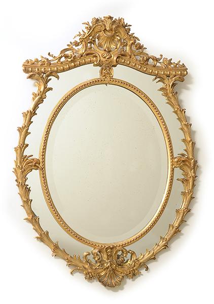 Appraisal: AN ORNATE FRENCH GILT WOOD FRAMED WALL MIRROR The oval