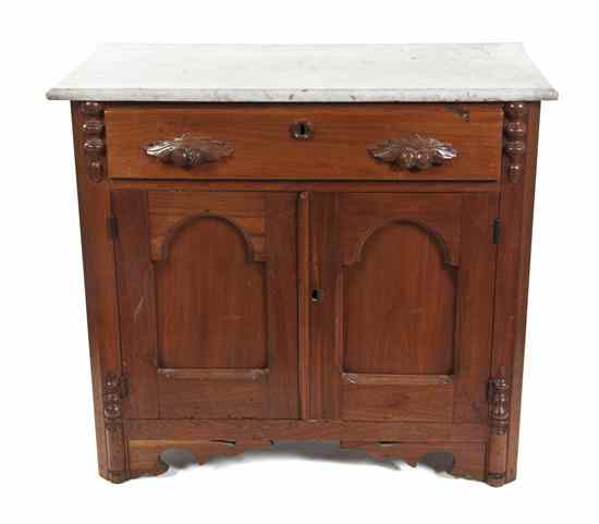 Appraisal: A Victorian Walnut Washstand the rectangular marble top over a