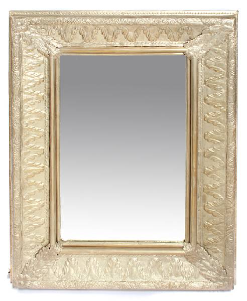 Appraisal: A Baroque style repousse decorated silvered metal mirror height ft