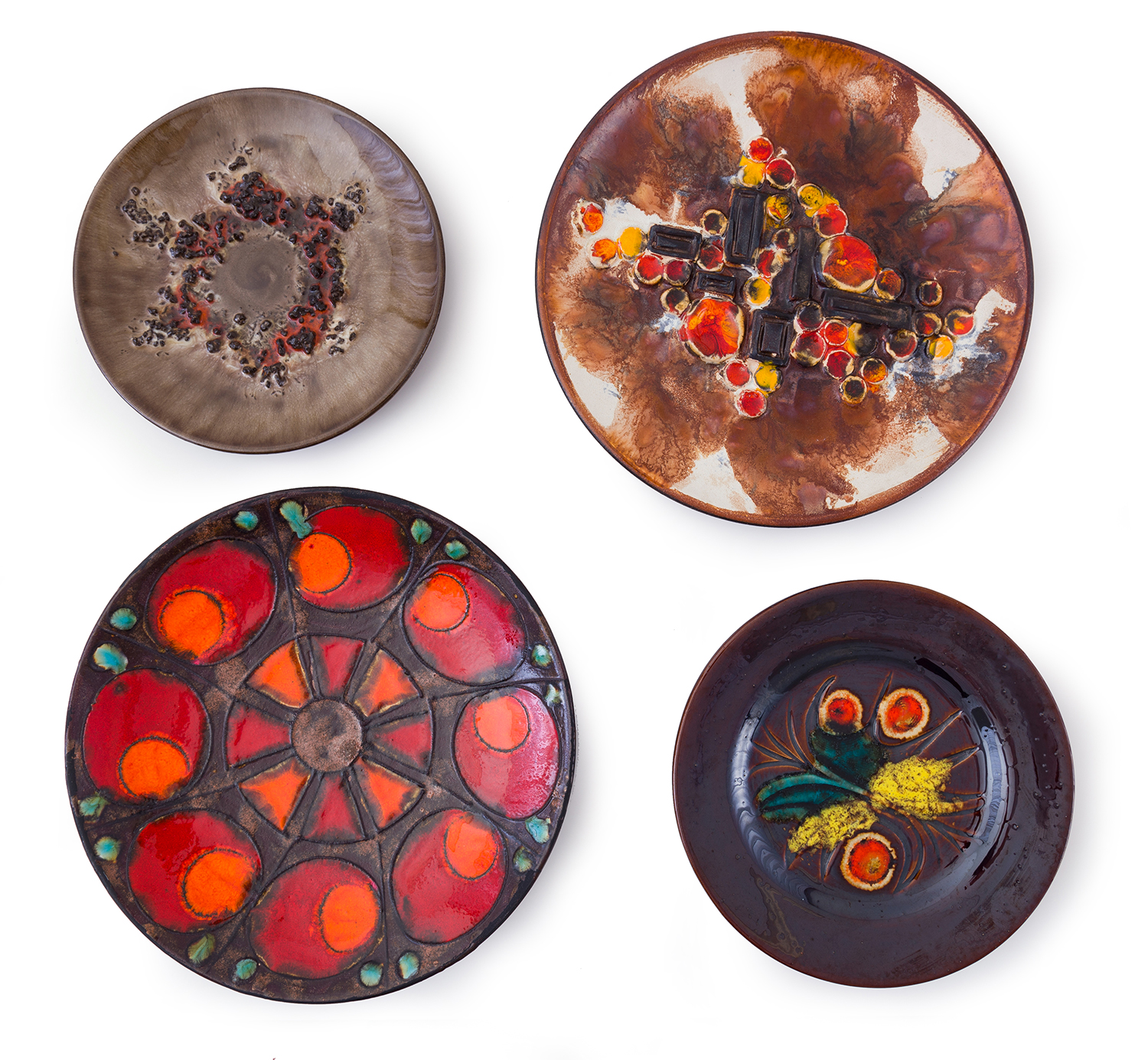 Appraisal: FOUR CERAMIC WALL PLATES Varying shapes and colours Australia c