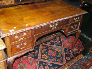 Appraisal: A mahogany dressing table th century the gadroon edged top