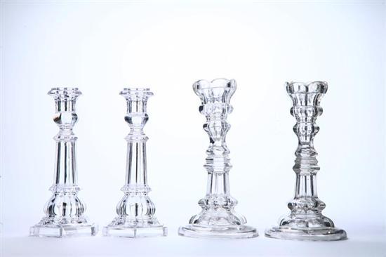 Appraisal: FOUR GLASS CANDLESTICKS Pittsburgh mid th century flint glass Two