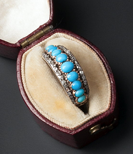 Appraisal: A TURQUOISE AND DIAMOND HALF HOOP RING centred with a