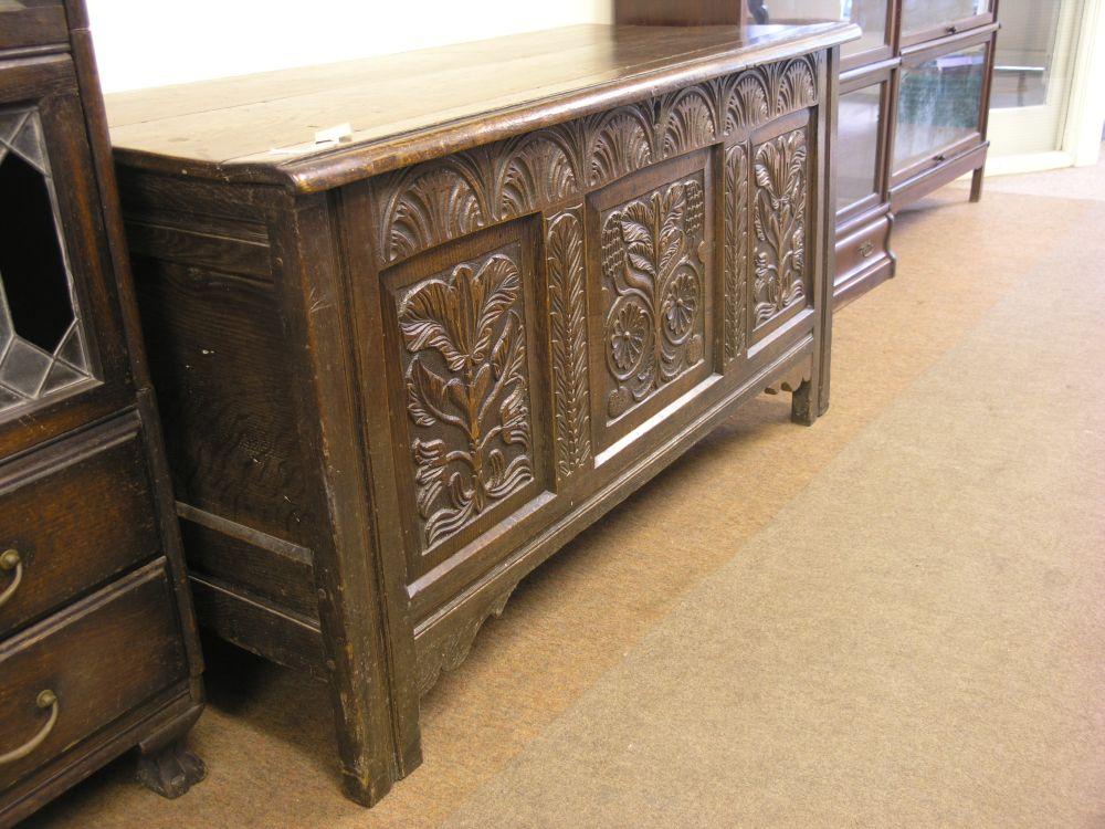 Appraisal: A late th century oak coffer the panelled front carved