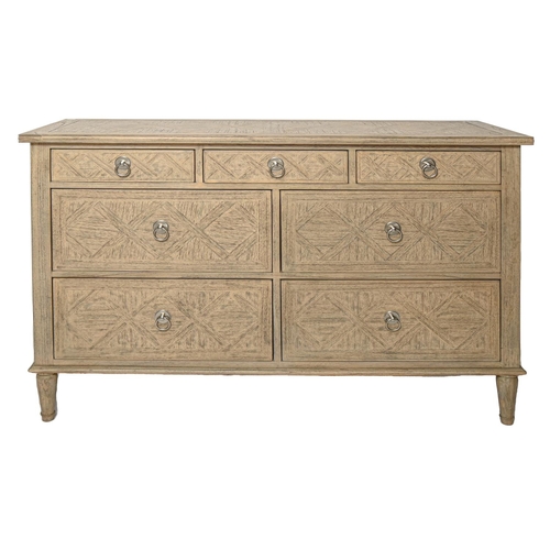 Appraisal: A limed wood chest of drawers with brushed stainless steel