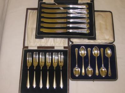 Appraisal: A SET OF SIX CAKE KNIVES with moulded hafts and