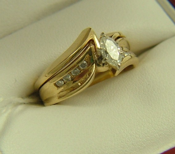 Appraisal: DIAMOND AND FOURTEEN KARAT GOLD RING set with a oval-cut