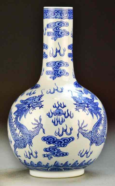 Appraisal: Chinese Blue and White Porcelain Bottle VaseDepicting dragons amongst ruyi