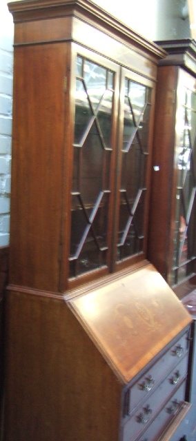 Appraisal: An Edwardian mahogany and satinwood banded bureau bookcase with a