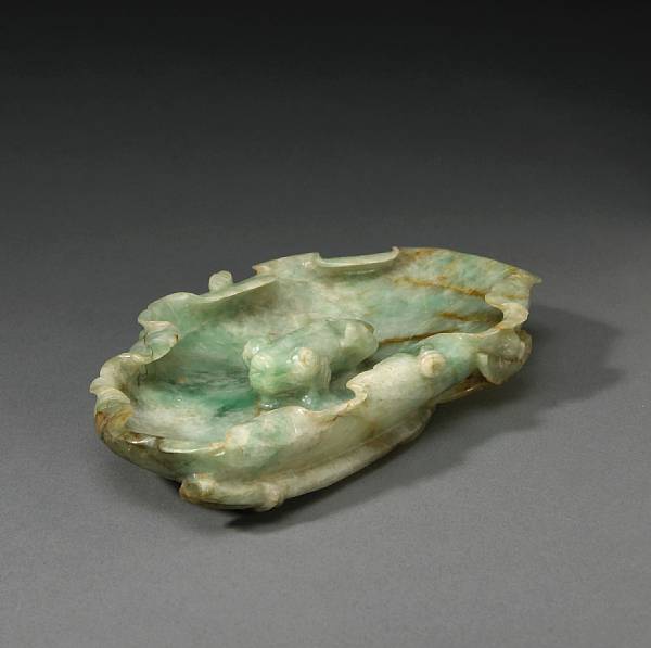 Appraisal: A mottled green jadeite lotus dish th Century Of oval