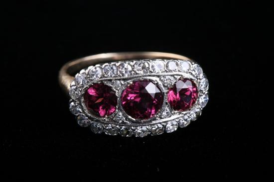 Appraisal: K YELLOW AND WHITE GOLD GARNET AND DIAMOND RING Circa