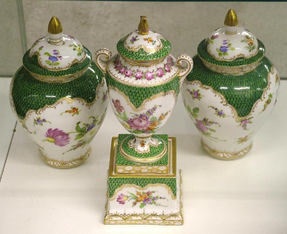 Appraisal: Dresden porcelain garniture comprising a pedestal baluster urn with cover