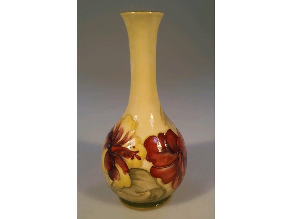 Appraisal: A Moorcroft bottle vase decorated with lilies on a yellow